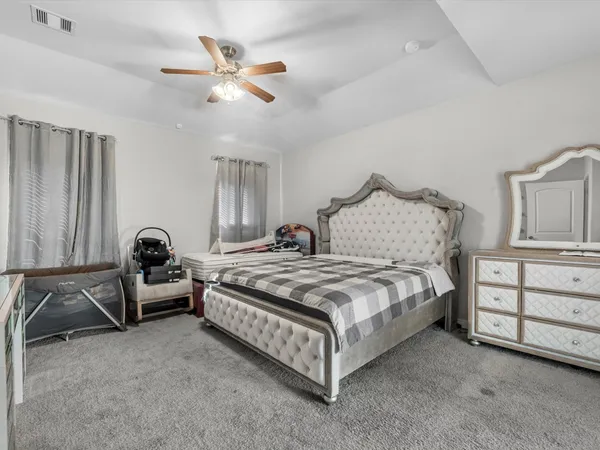 a spacious bedroom with a bed and furniture