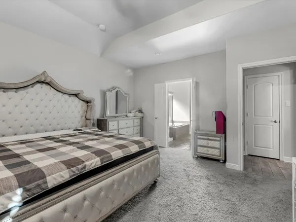 a bedroom with bed and a couch