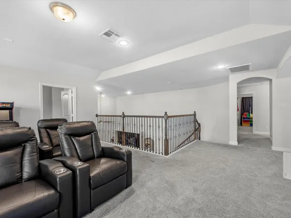 a living room with furniture and a ceiling fan