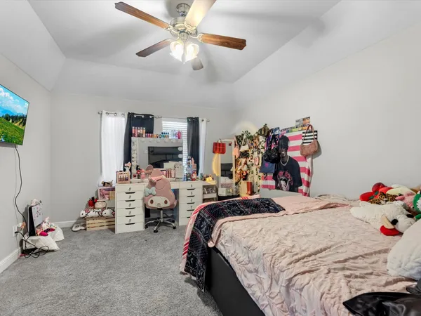 a bedroom with bed and a chandelier