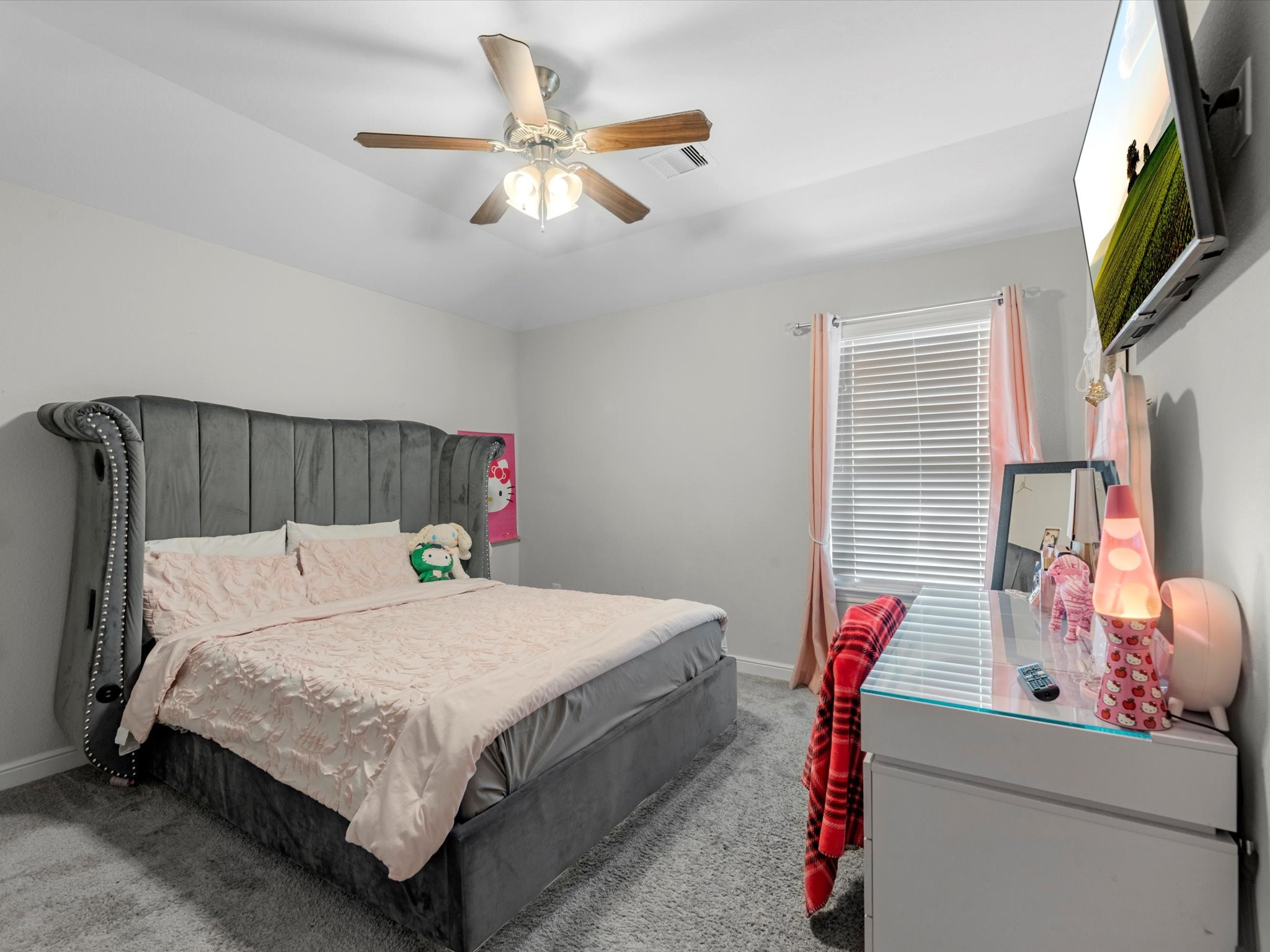 2822 Knotty Frst Drive Spring, TX 77373 - Photo 26 of 29 a bedroom with a bed a flat screen tv and a chandelier