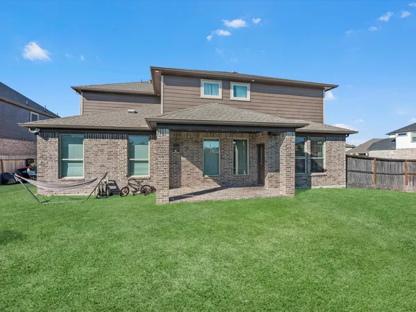 a view of a house with a yard and sitting area