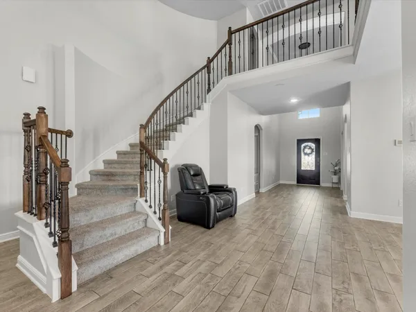 a view of entryway and hall with wooden floor