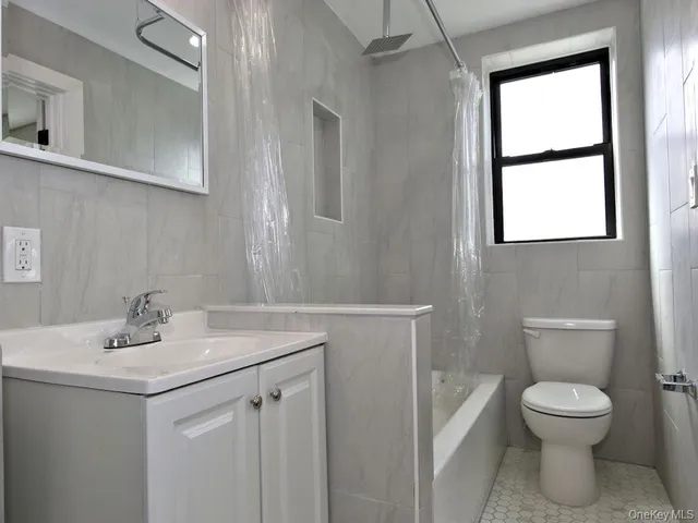 a bathroom with a sink mirror and toilet