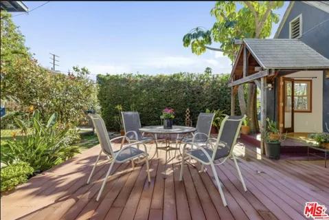a view of deck with table and chairs and wooden floor