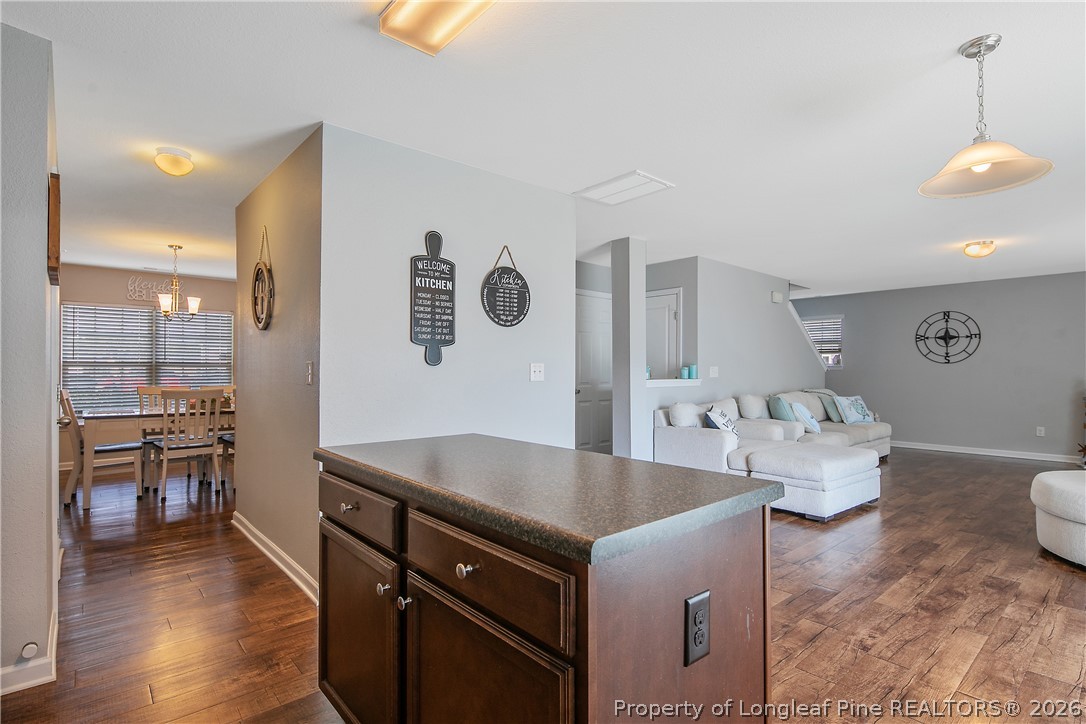 340 Battery Way Bunnlevel, NC 28323 - Photo 13 of 50 a living room with couches and kitchen view with wooden floor