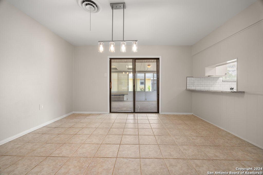 221 Windcrest Drive Windcrest, TX 78239 - Photo 9 of 28 a view of an empty room with chandelier and kitchen view
