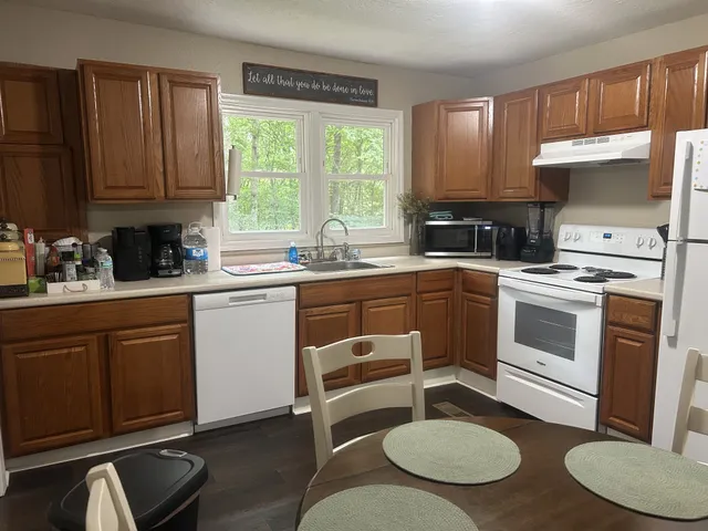 a kitchen with a stove a sink and a refrigerator