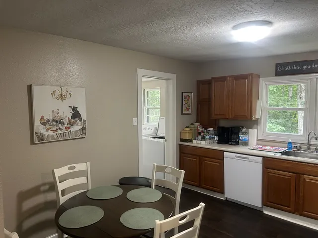 a kitchen with a sink stove and white cabinets
