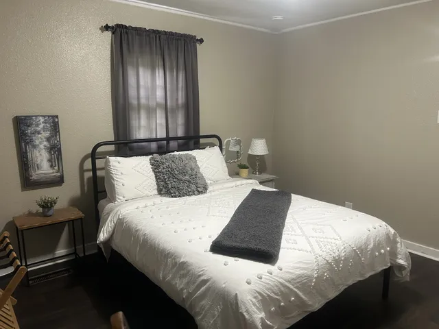 a bedroom with a bed and window