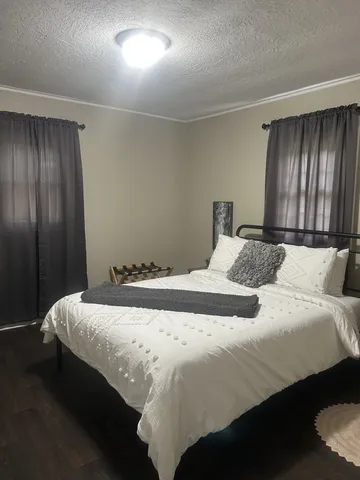 a bedroom with bed and window