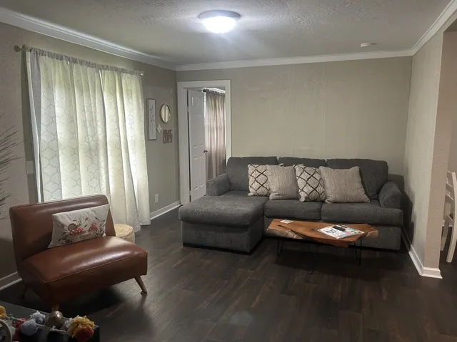 a living room with furniture and a large window