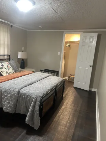 a bedroom with a bed and a mirror