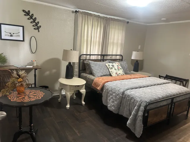 a bedroom with bed and a table