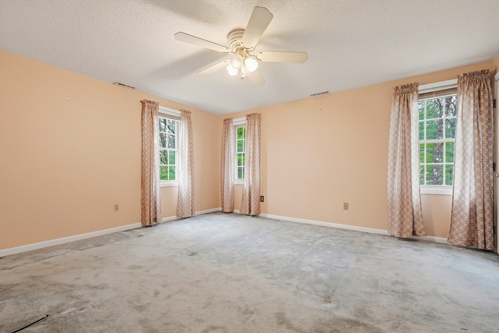 3301 Maple Brook Road, Unit 301 Bellingham, MA 02019 - Photo 24 of 29 an empty room with windows and fan