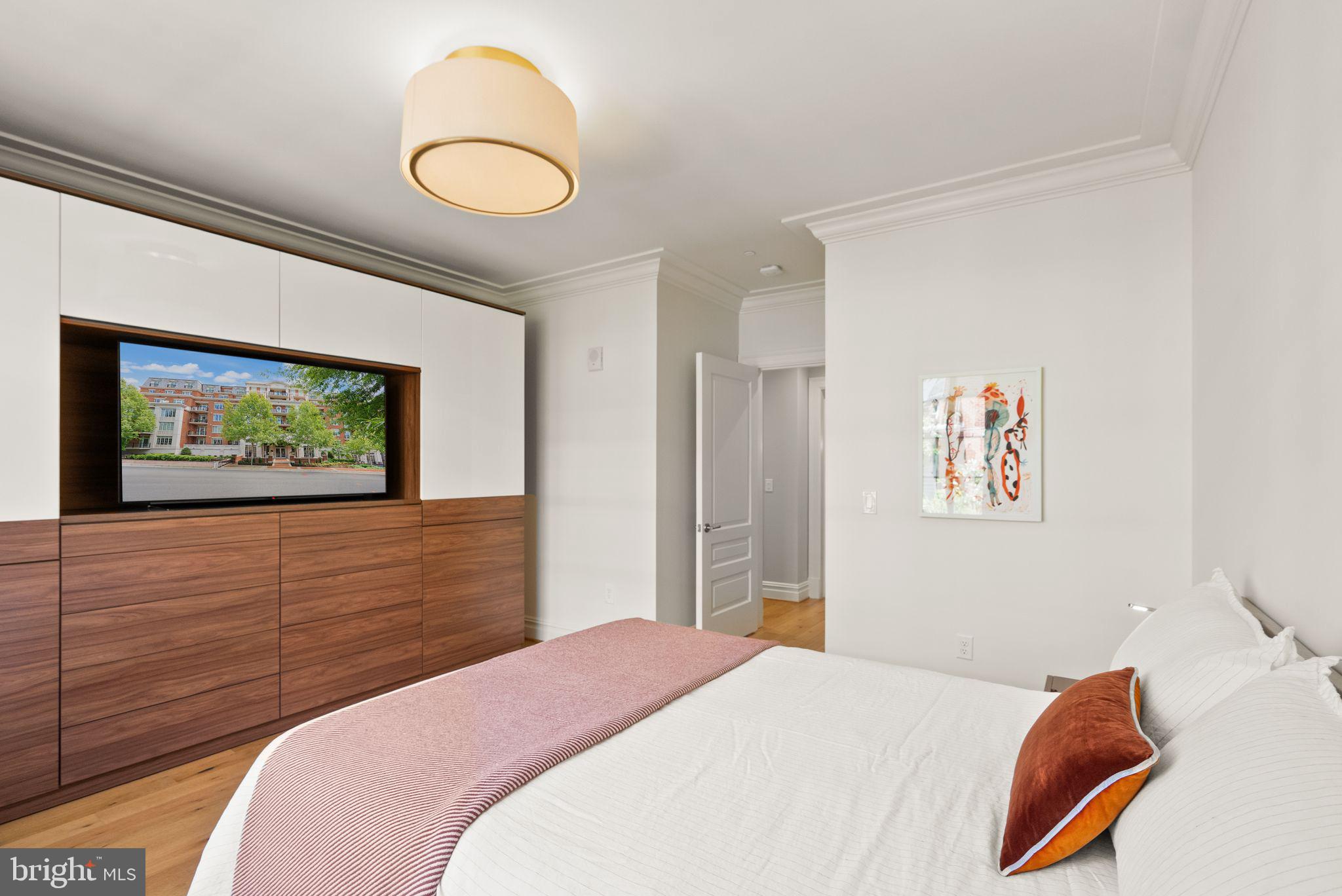6900 Fleetwood Road, Unit 415 McLean, VA 22101 - Photo 21 of 51 a bedroom with a bed and a painting on the wall