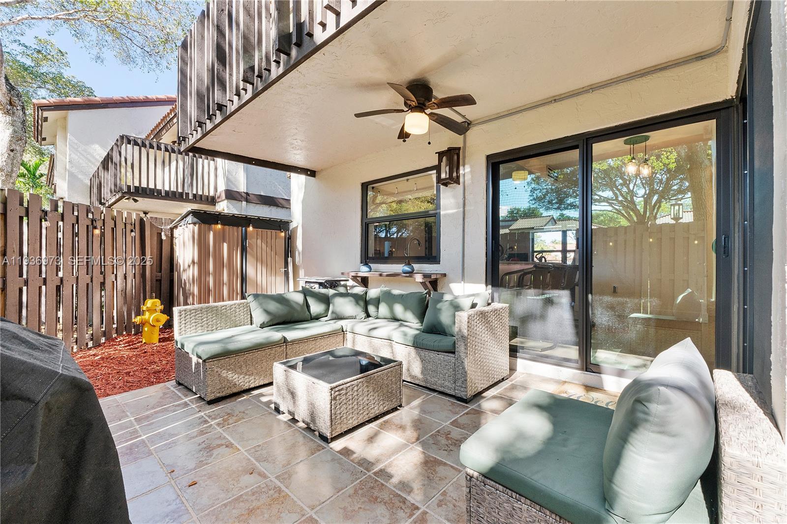13234 Southwest 111th Terrace, Unit 44 Miami, FL 33186 - Photo 20 of 29 a living room with fireplace furniture and a large window