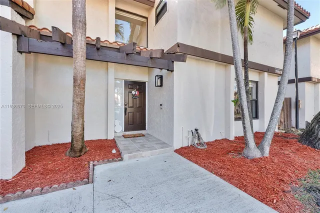 a kitchen with white cabinets stainless steel appliances and sink