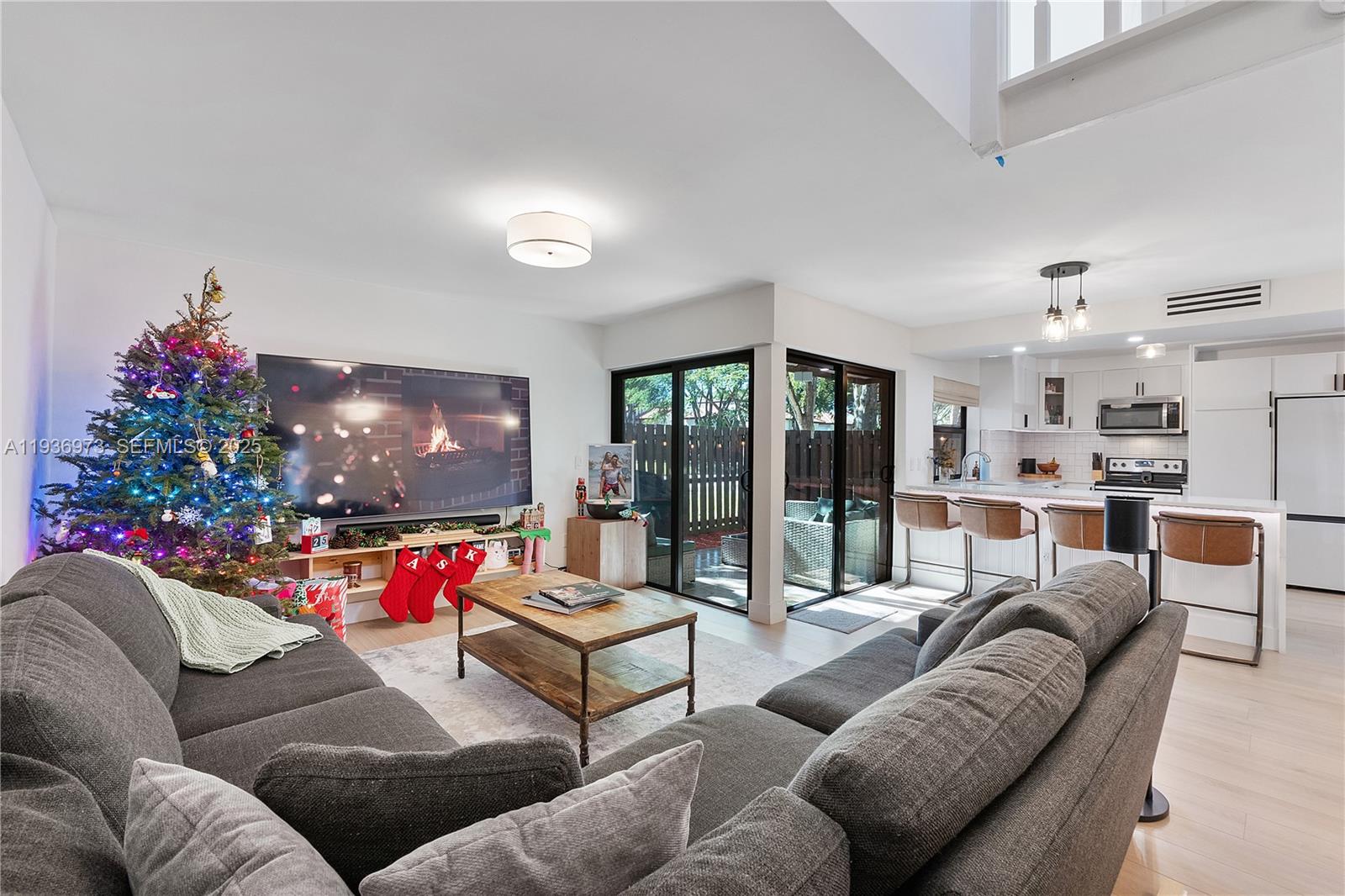 13234 Southwest 111th Terrace, Unit 44 Miami, FL 33186 - Photo 3 of 29 a living room with furniture and a flat screen tv
