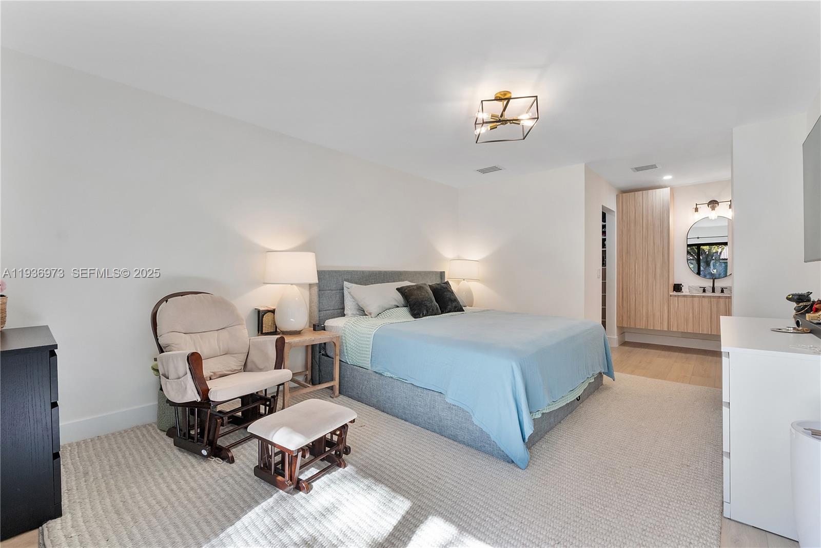 13234 Southwest 111th Terrace, Unit 44 Miami, FL 33186 - Photo 8 of 29 a bedroom with bed and a chandelier