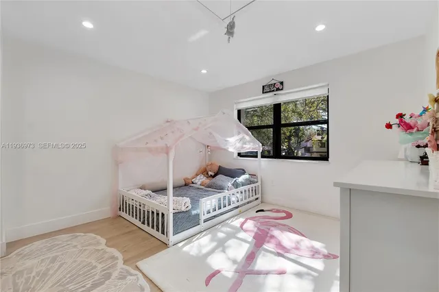 a bedroom with a bed and cabinets