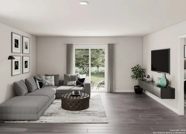 a living room with furniture floor to ceiling window and a flat screen tv