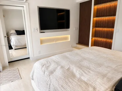 a bedroom with a bed and a couch