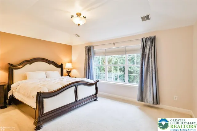 a bedroom with a bed and a mirror