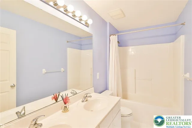 an aerial view of residential house with outdoor space and trees all around