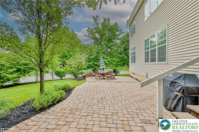 a white house that has tree in front of it