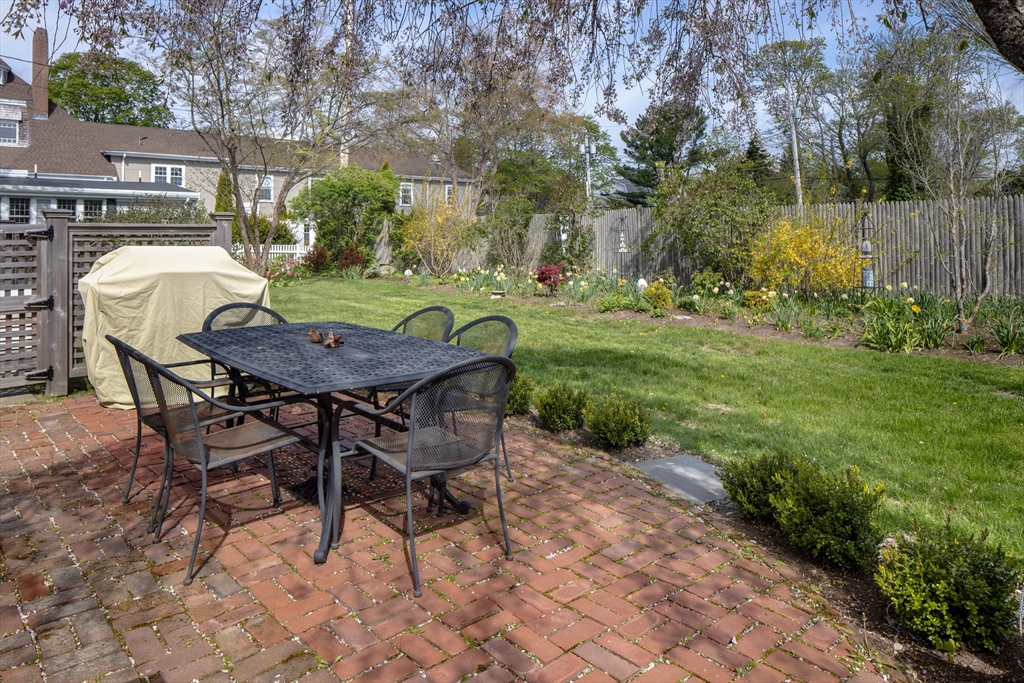 31 Main Street Marion, MA 02738 - Photo 10 of 29 a backyard of a house with table and chairs