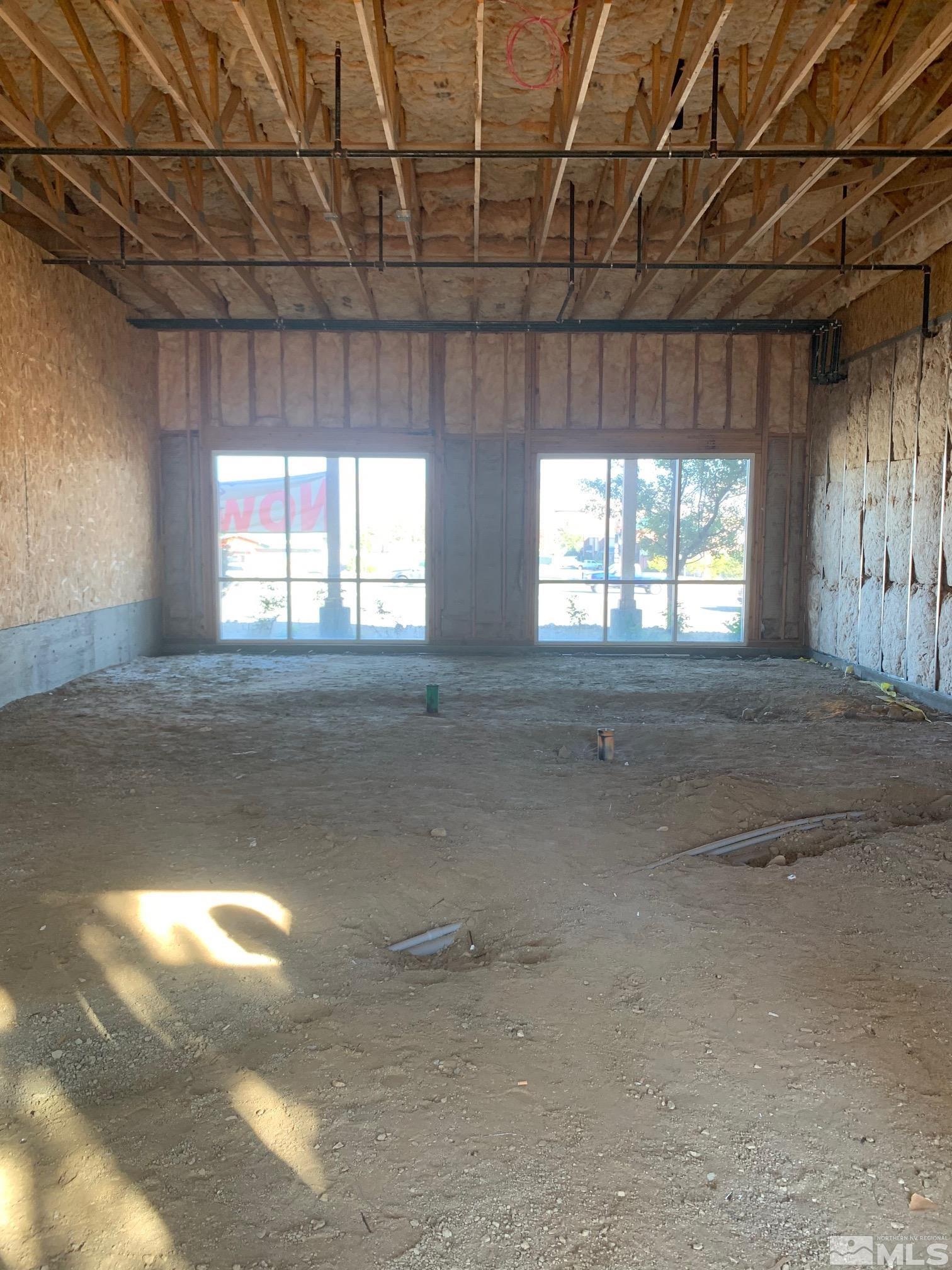 a view of an empty room with windows