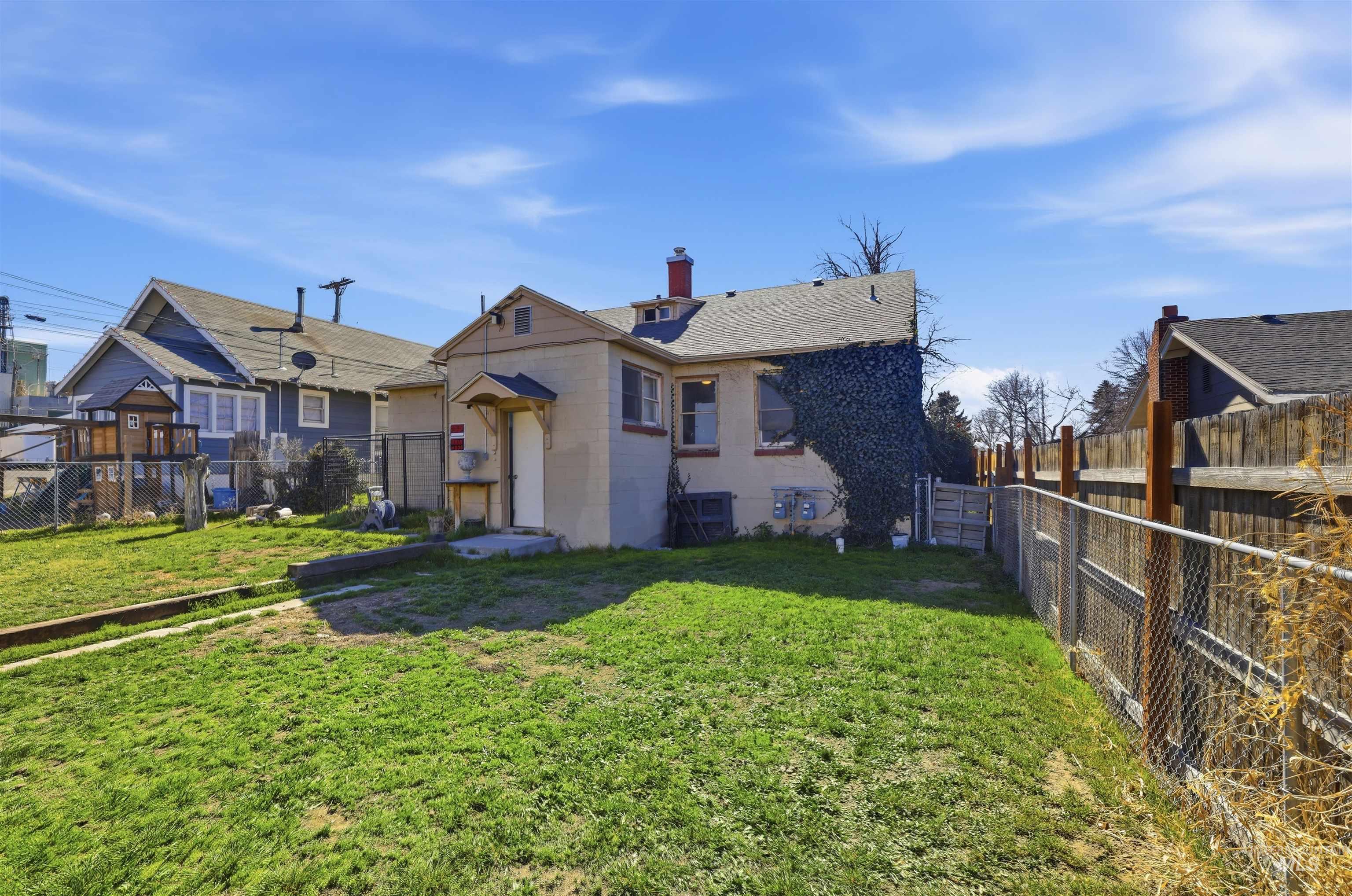 116 13th Avenue North Buhl, ID 83316 - Photo 19 of 37 Rear view of property featuring a chimney, a fenced backyard, and roof with shingles