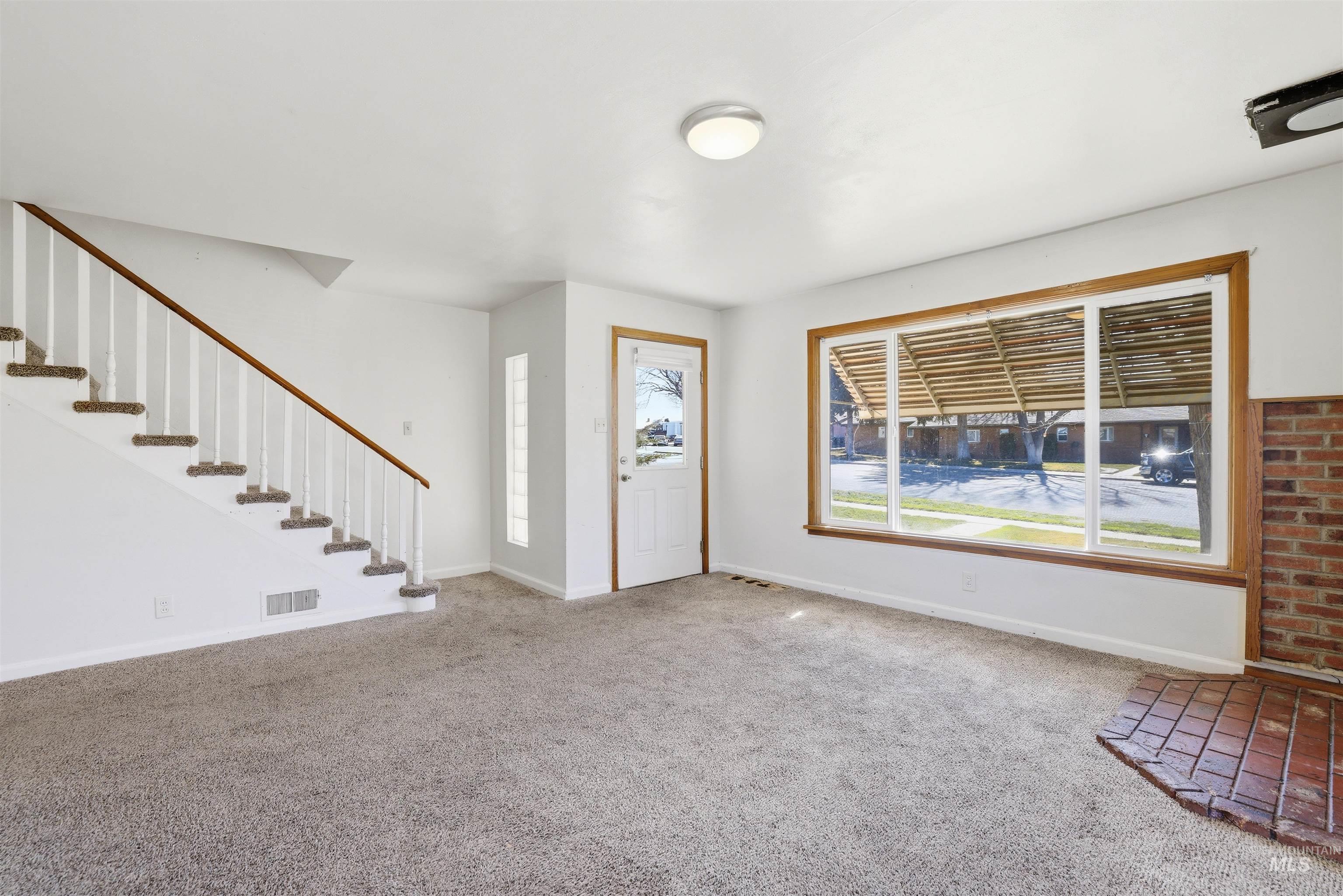 116 13th Avenue North Buhl, ID 83316 - Photo 2 of 37 Carpeted entryway with stairs and baseboards
