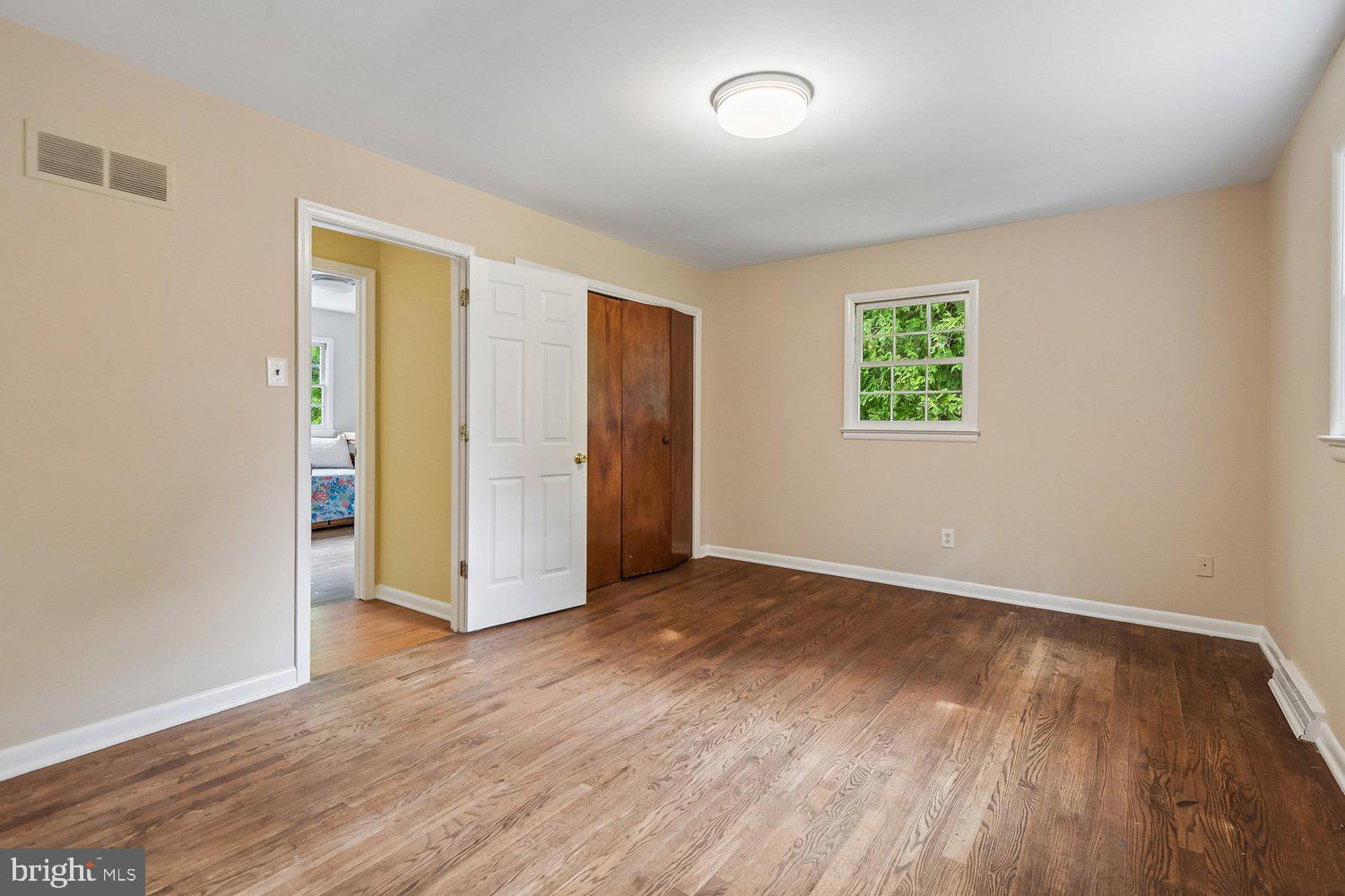 1518 Winchester Road Annapolis, MD 21409 - Photo 30 of 70 an empty room with wooden floor and windows