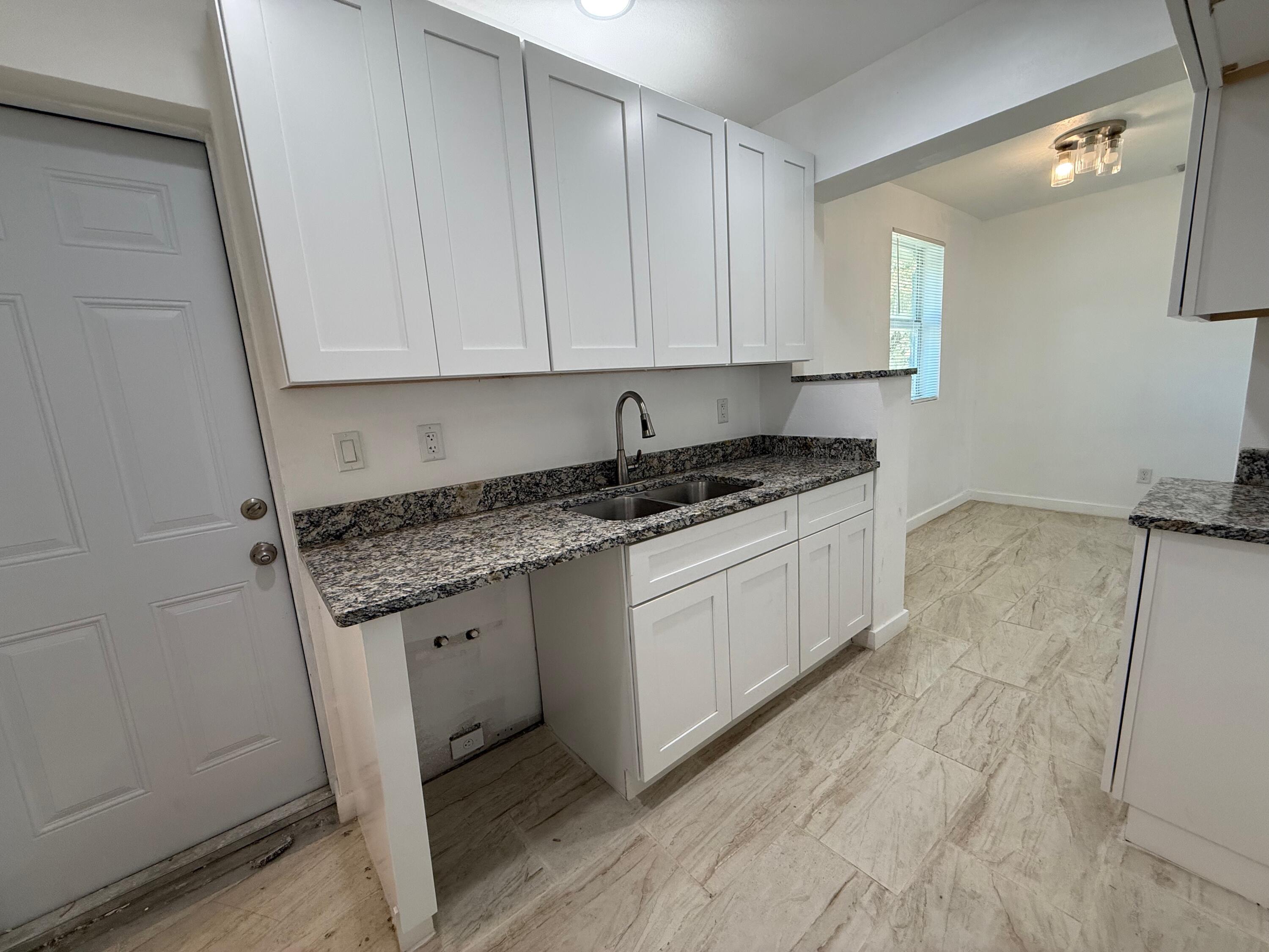 2104 North 53rd Street Fort Pierce, FL 34946 - Photo 8 of 15 KITCHEN TO DINING ROOM