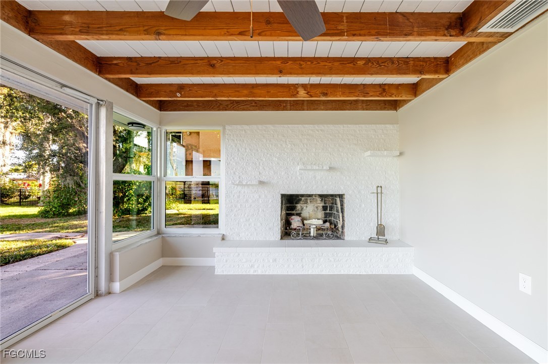 14502 Riverside Drive Fort Myers, FL 33905 - Photo 12 of 33 a view of an empty room with a fireplace and a window