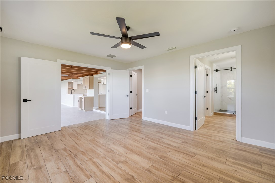 14502 Riverside Drive Fort Myers, FL 33905 - Photo 15 of 33 wooden floor in an empty room with a window