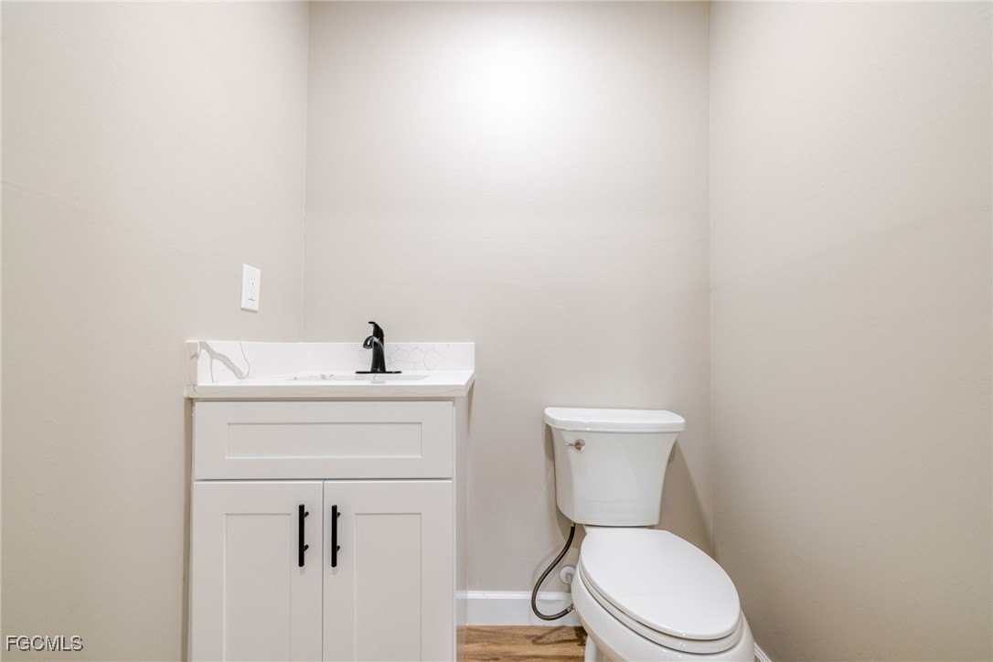 14502 Riverside Drive Fort Myers, FL 33905 - Photo 17 of 33 a bathroom with a toilet a sink and mirror