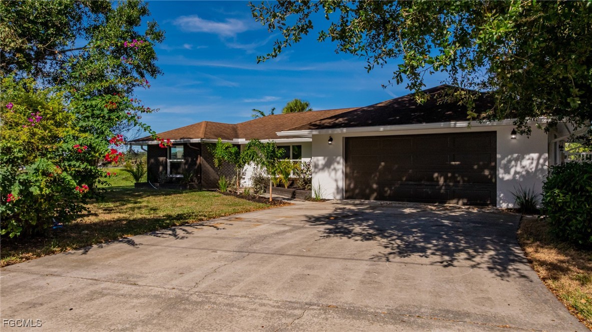 14502 Riverside Drive Fort Myers, FL 33905 - Photo 31 of 33 a front view of a house with a yard and garage