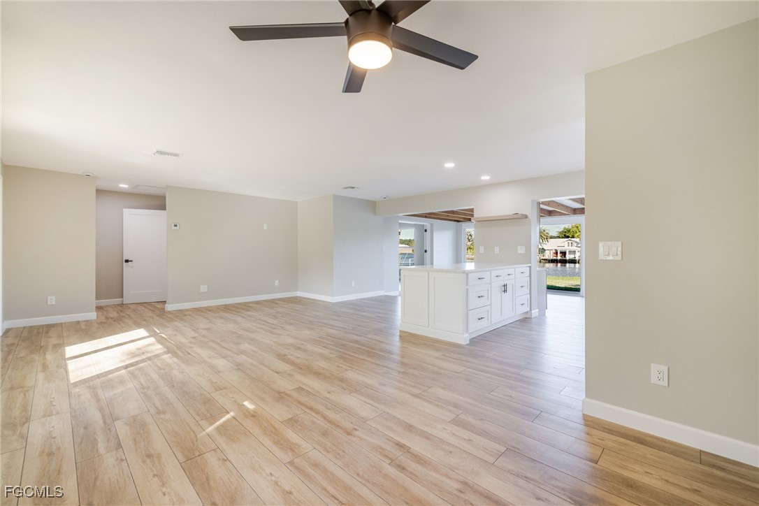 14502 Riverside Drive Fort Myers, FL 33905 - Photo 7 of 33 a view of empty room with wooden floor and window