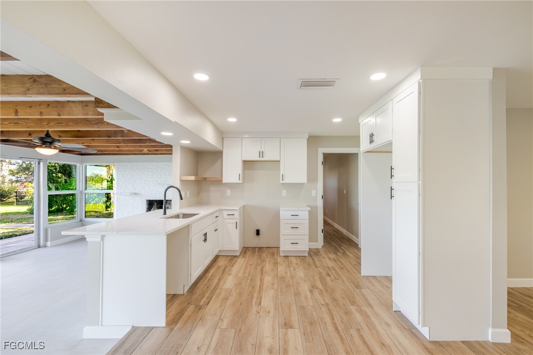 14502 Riverside Drive Fort Myers, FL 33905 - Photo 9 of 33 a large kitchen with a lot of counter space and a wooden floor