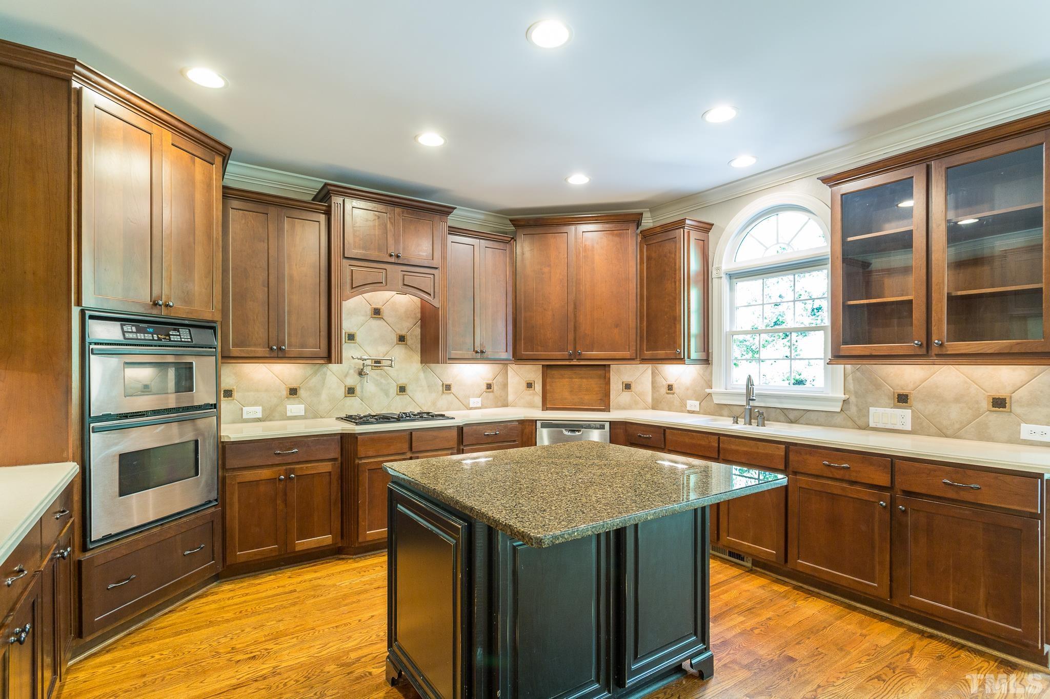 12008 Joseph Drive Raleigh, NC 27614 - Photo 8 of 25 Stainless appliances, tile backsplash, walk-in pantry, recessed lighting, hardwoods floors, and crown molding.