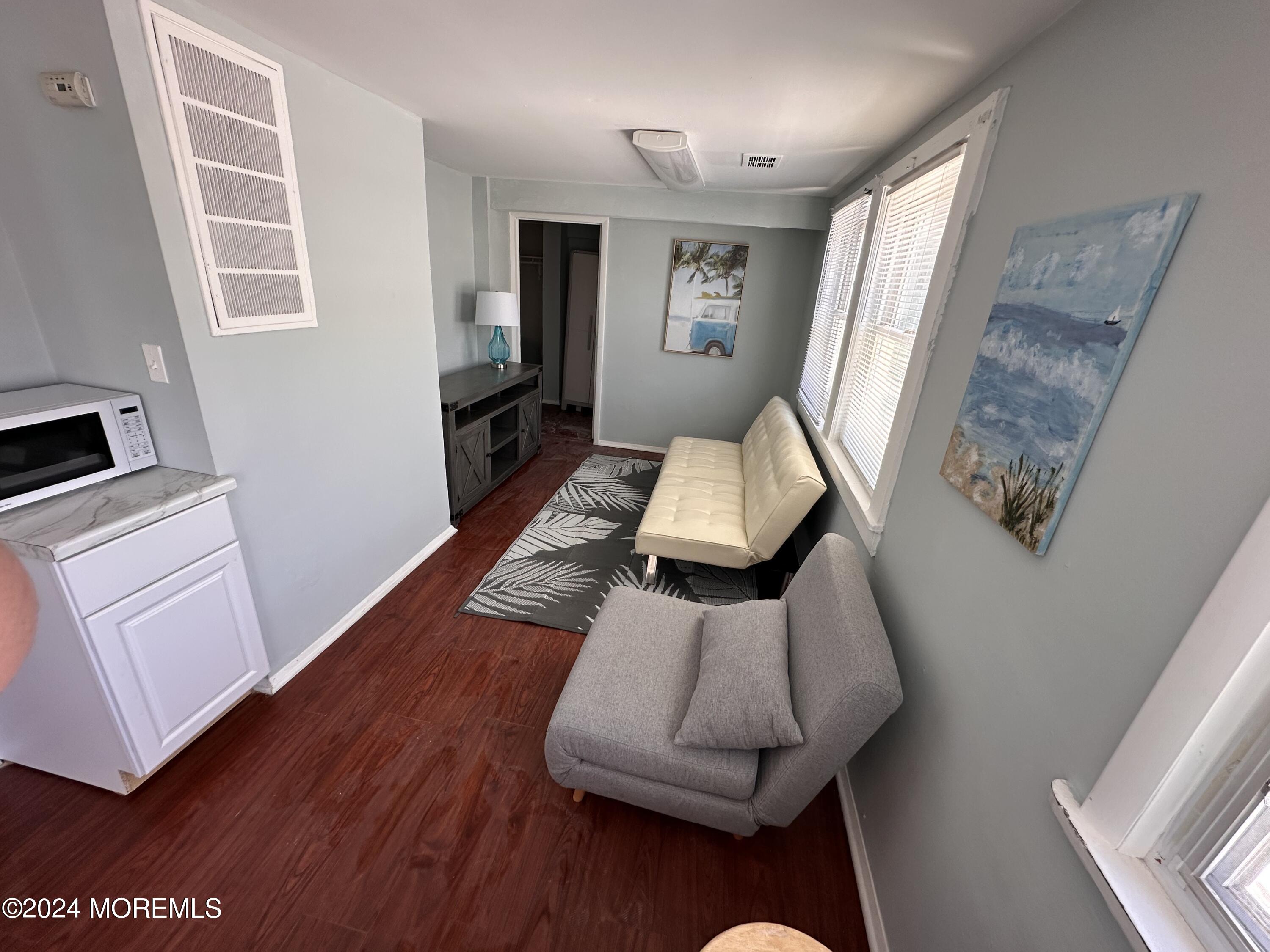 116 12th Avenue, Unit B Belmar, NJ 07719 - Photo 1 of 5 a living room with furniture and a wooden floor
