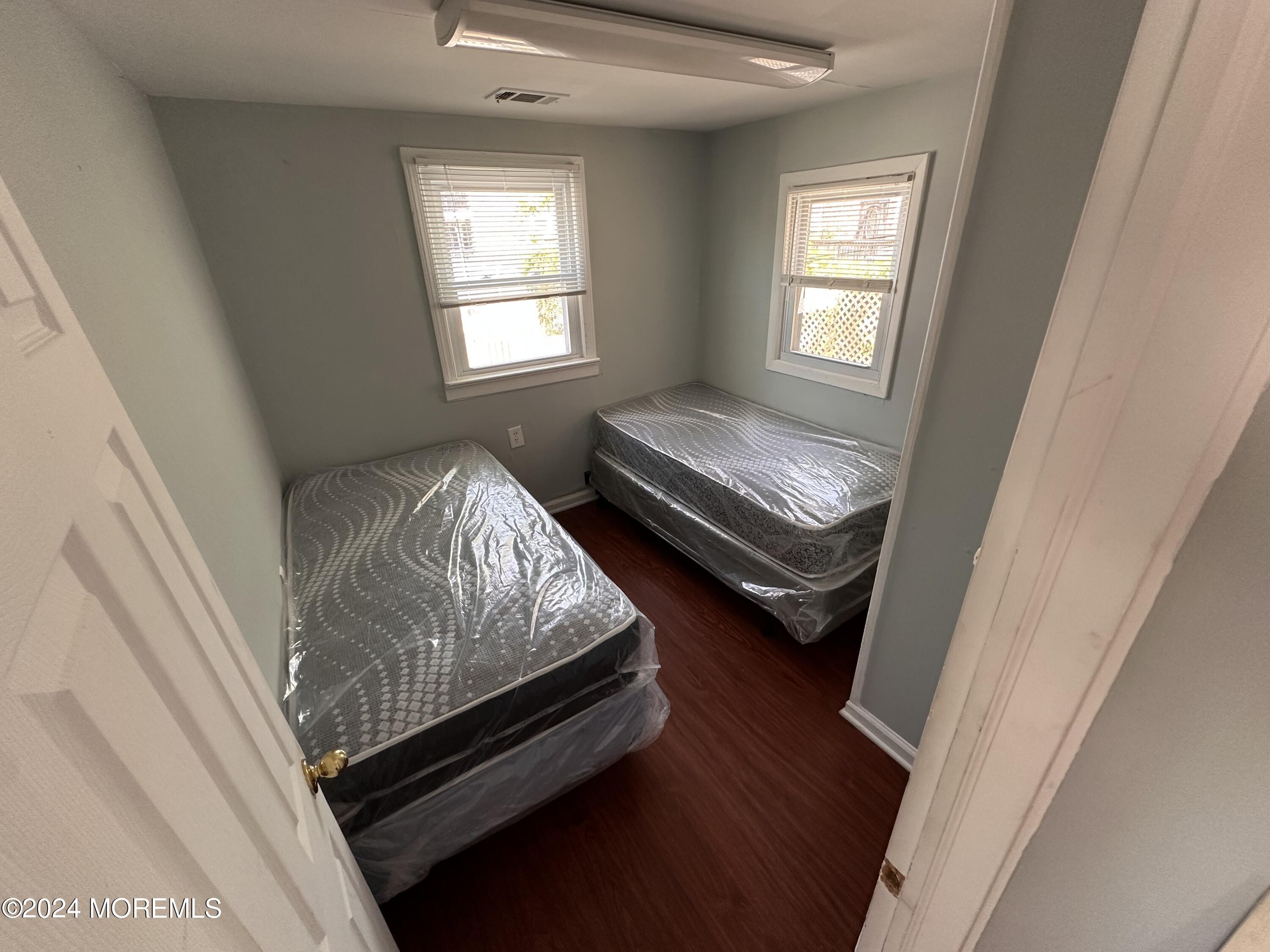 116 12th Avenue, Unit B Belmar, NJ 07719 - Photo 4 of 5 a bed sitting in a bedroom next to a window