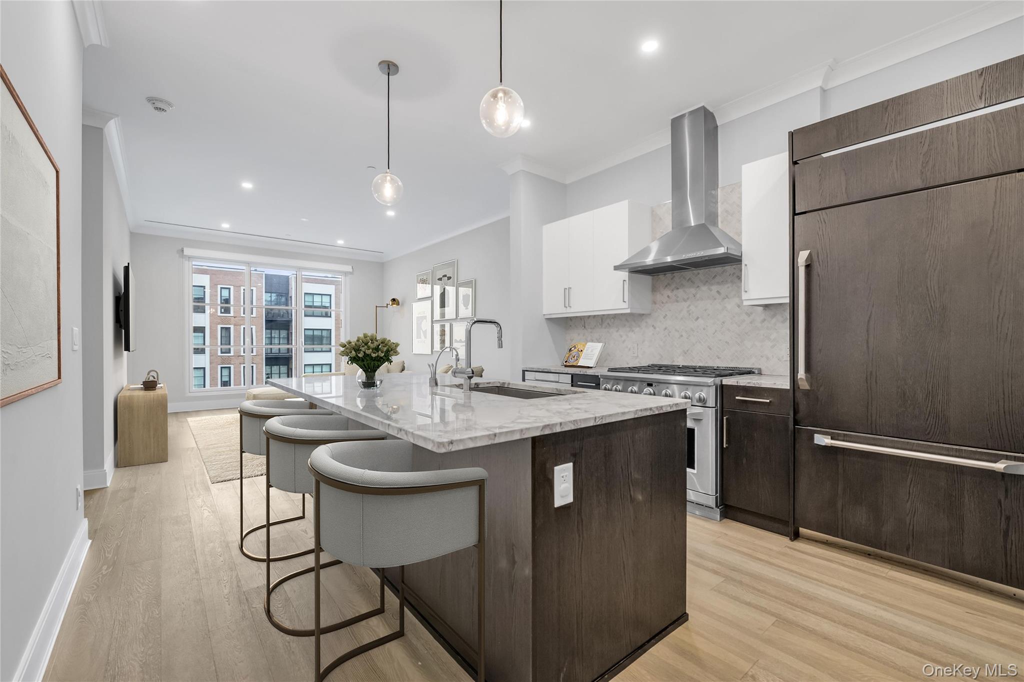 100 Garvies Point Road, Unit 1238 Glen Cove, NY 11542 - Photo 15 of 41 a kitchen with stainless steel appliances granite countertop a sink a stove a refrigerator and island with wooden floor