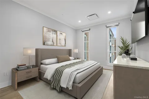 a bedroom with a bed and a potted plant