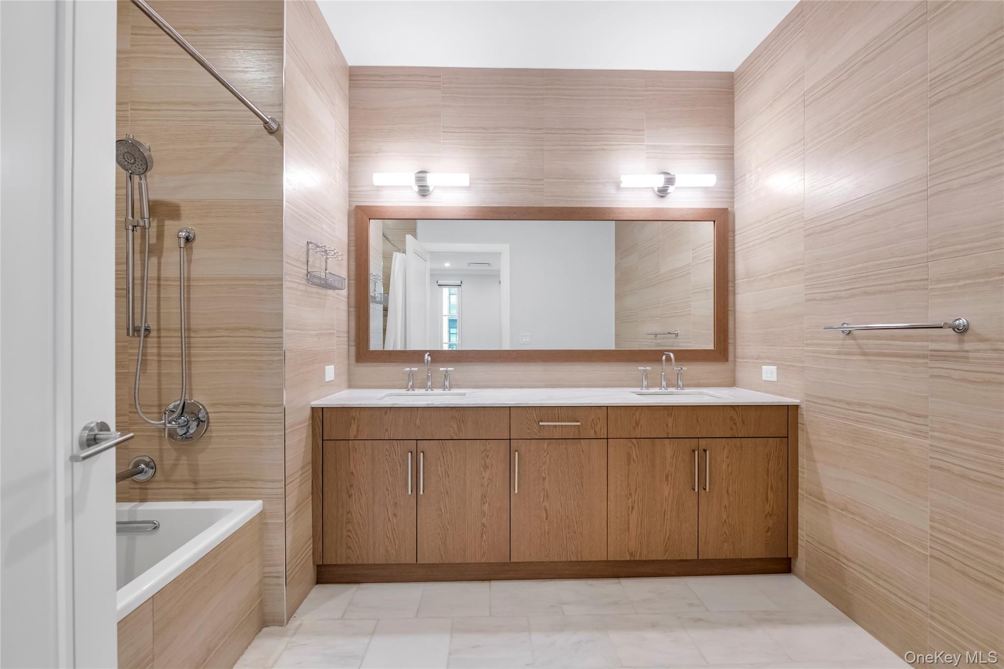 100 Garvies Point Road, Unit 1238 Glen Cove, NY 11542 - Photo 17 of 41 a bathroom with a tub a sink and mirror