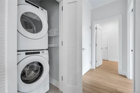 a view of a hallway with washer and dryer