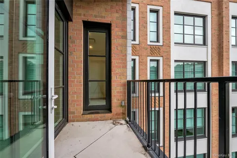 a view of a brick house with a large window